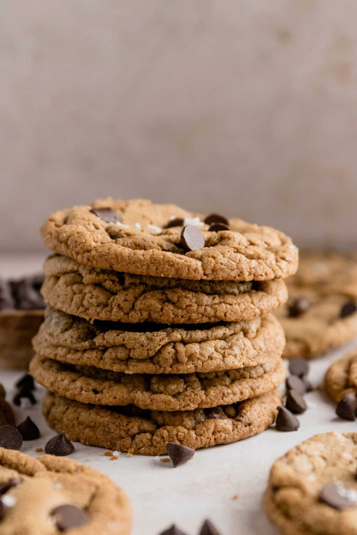 a stack of gluten free chocolate chip cookies with sea salt flakes