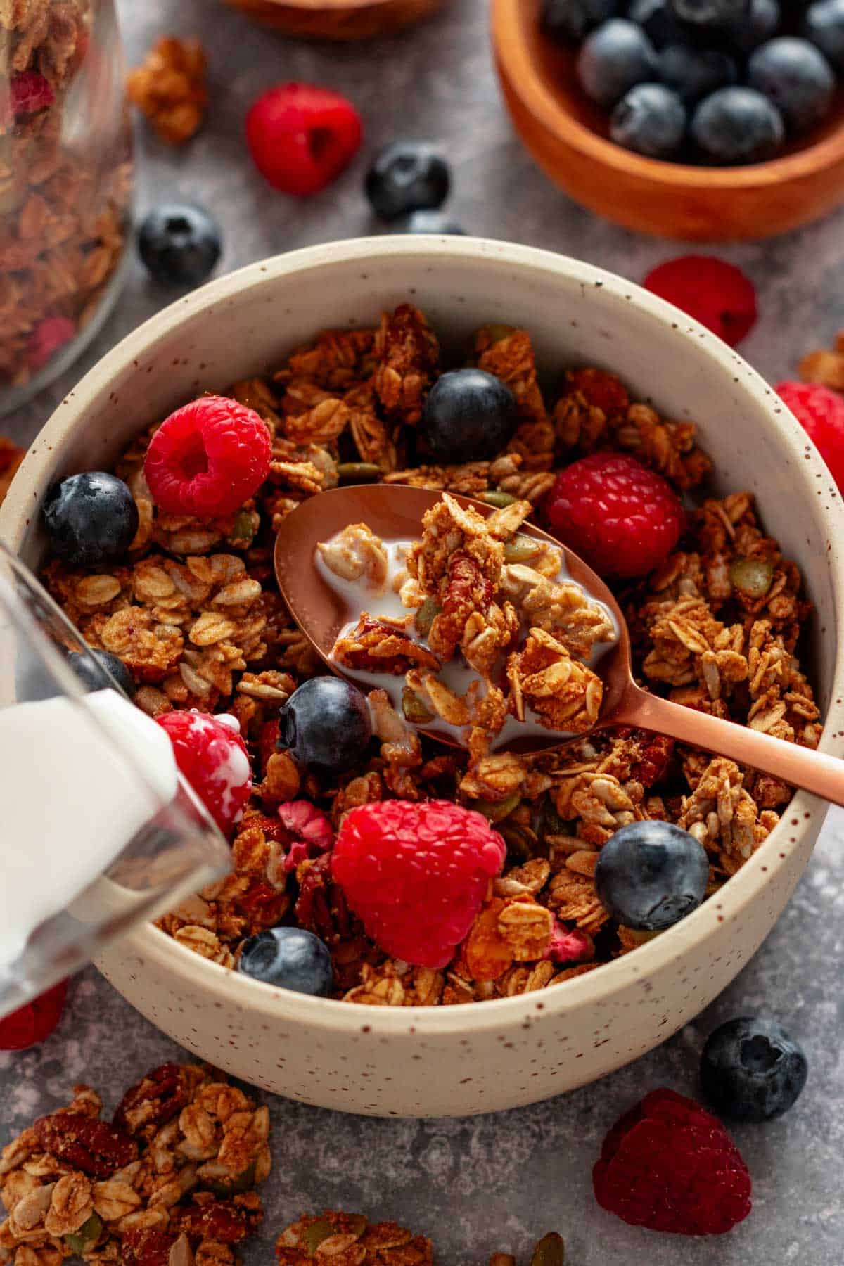 homemade gluten free granola in a bowl with berries