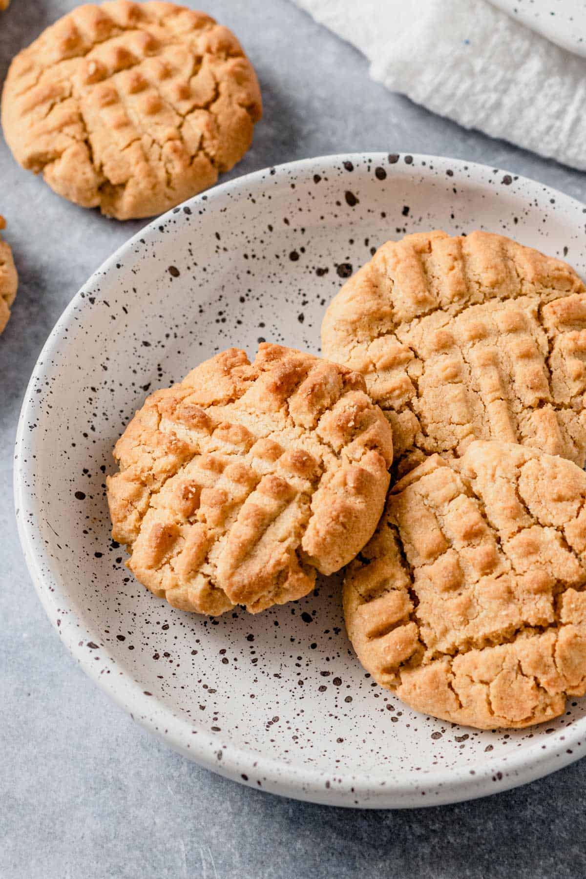 peanut butter cookies stacked on a plate