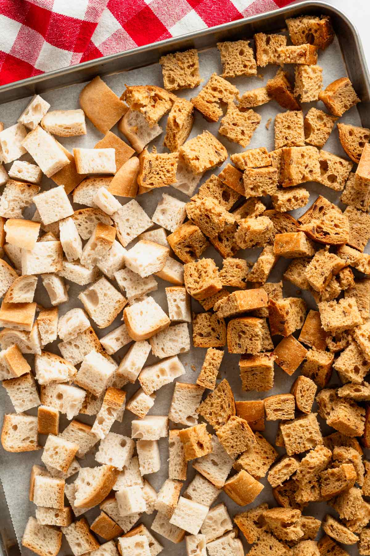 two types of bread cubes on baking sheet.