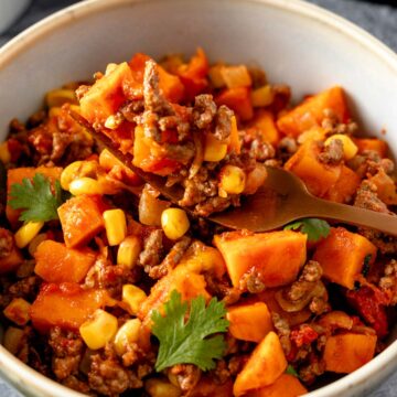 ground beef and sweet potatoes in a bowl with cheese.