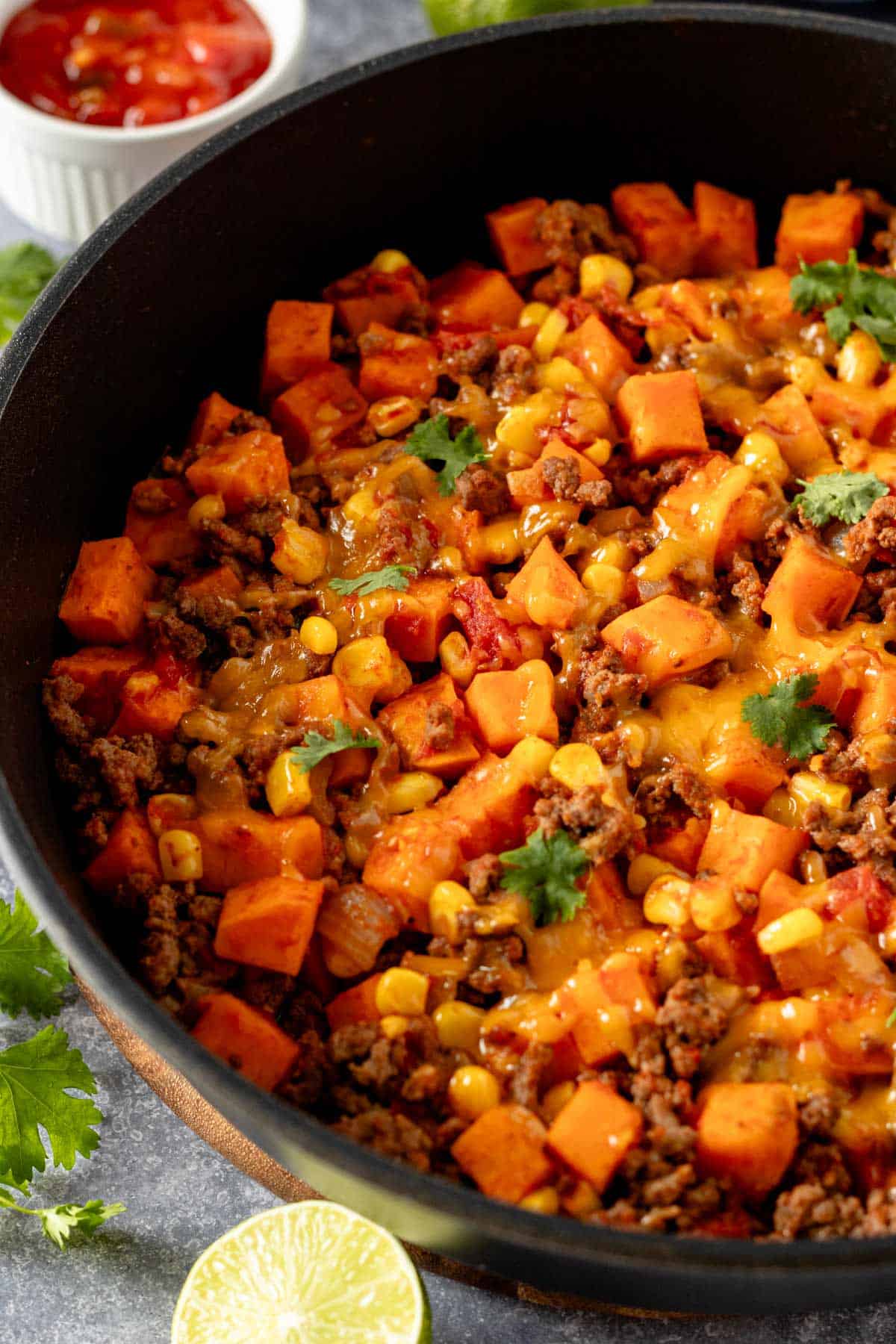 ground beef and sweet potatoes in skillet with cheese.