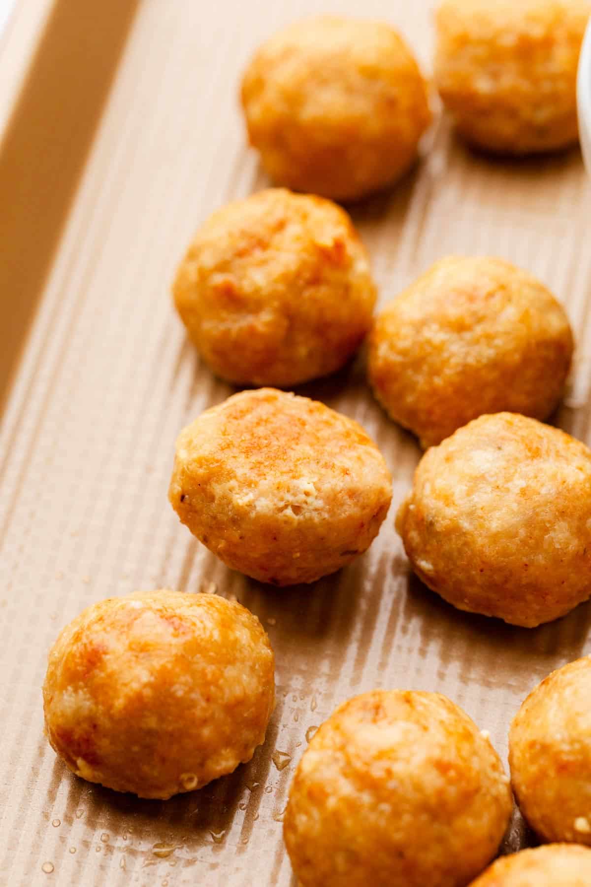 Golden brown ground chicken meatballs.