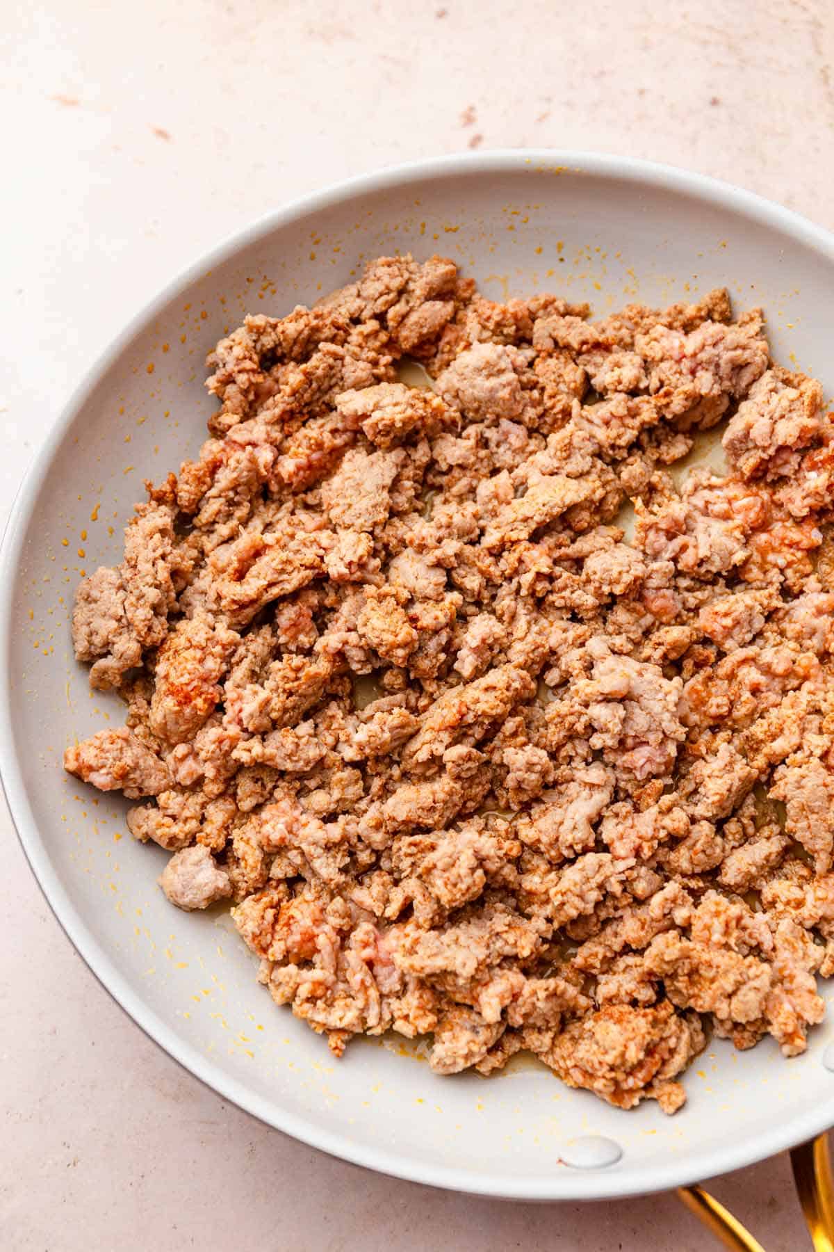 Browned ground turkey in a skillet.