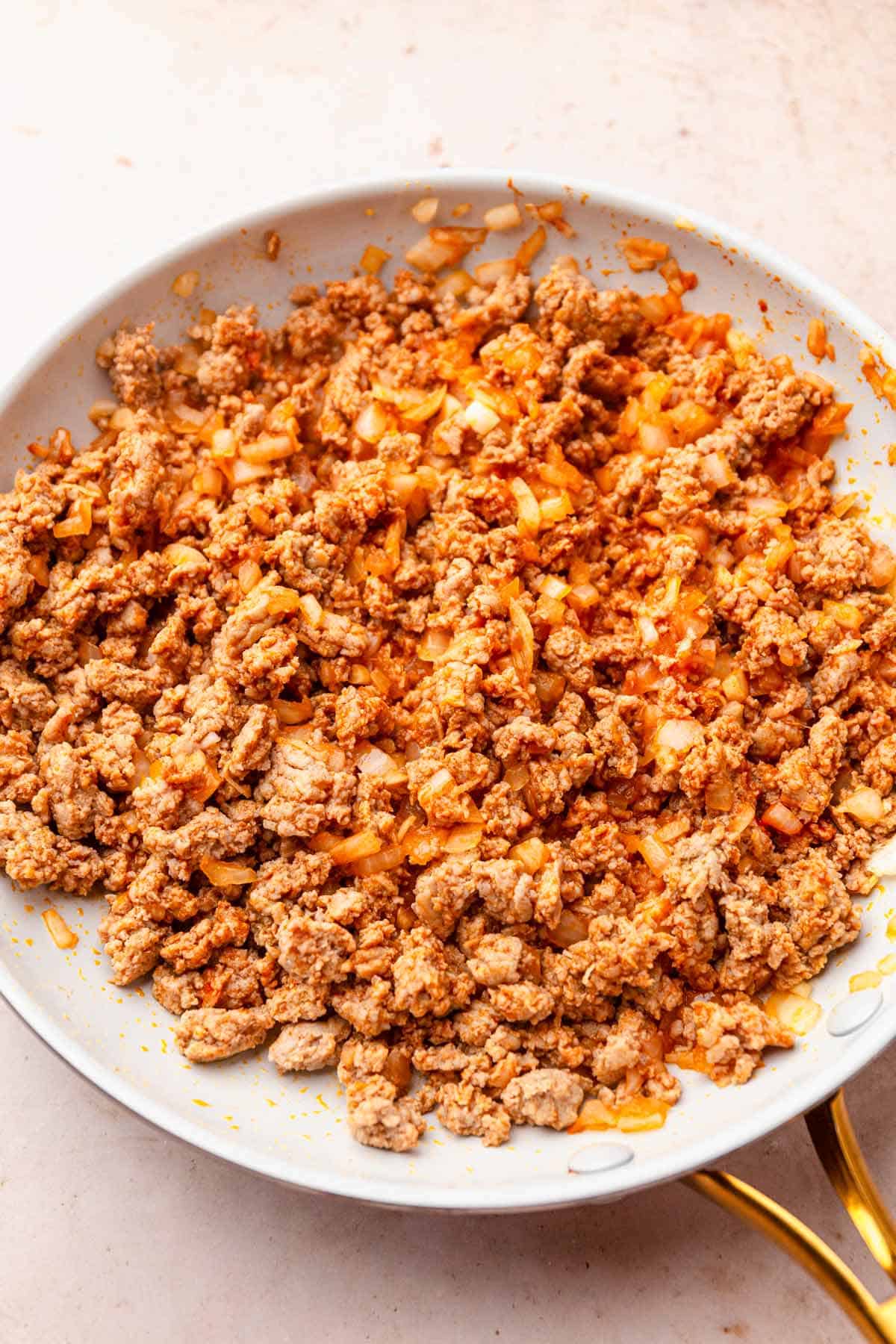 Browned ground turkey in a skillet.