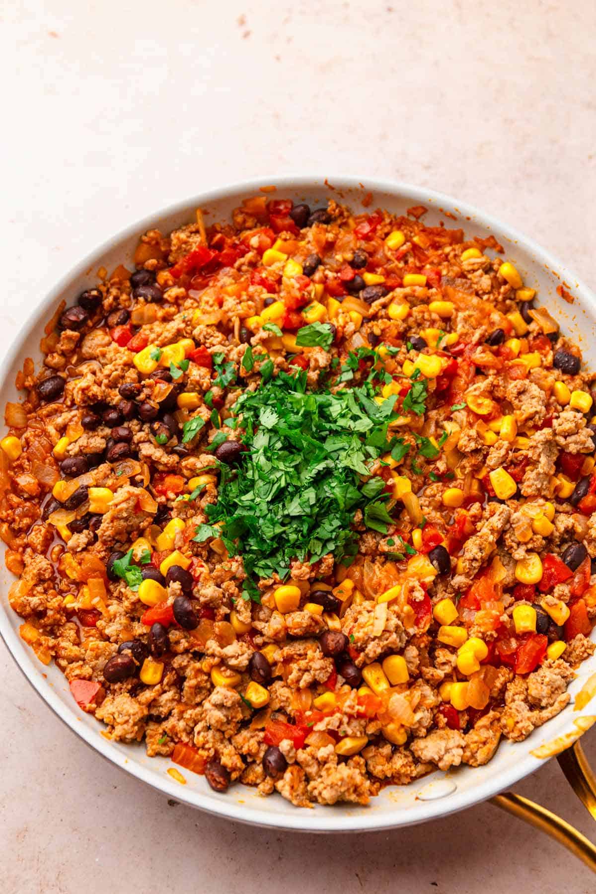 Browned ground turkey in a skillet.