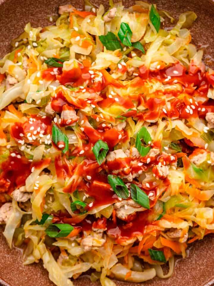 Ground turkey cabbage stir fry with sriracha and sesame seeds.