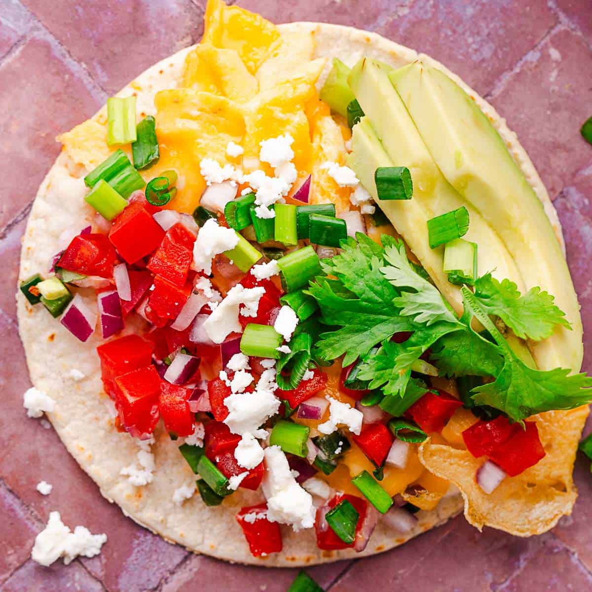 breakfast tacos with avocado and tomatoes.