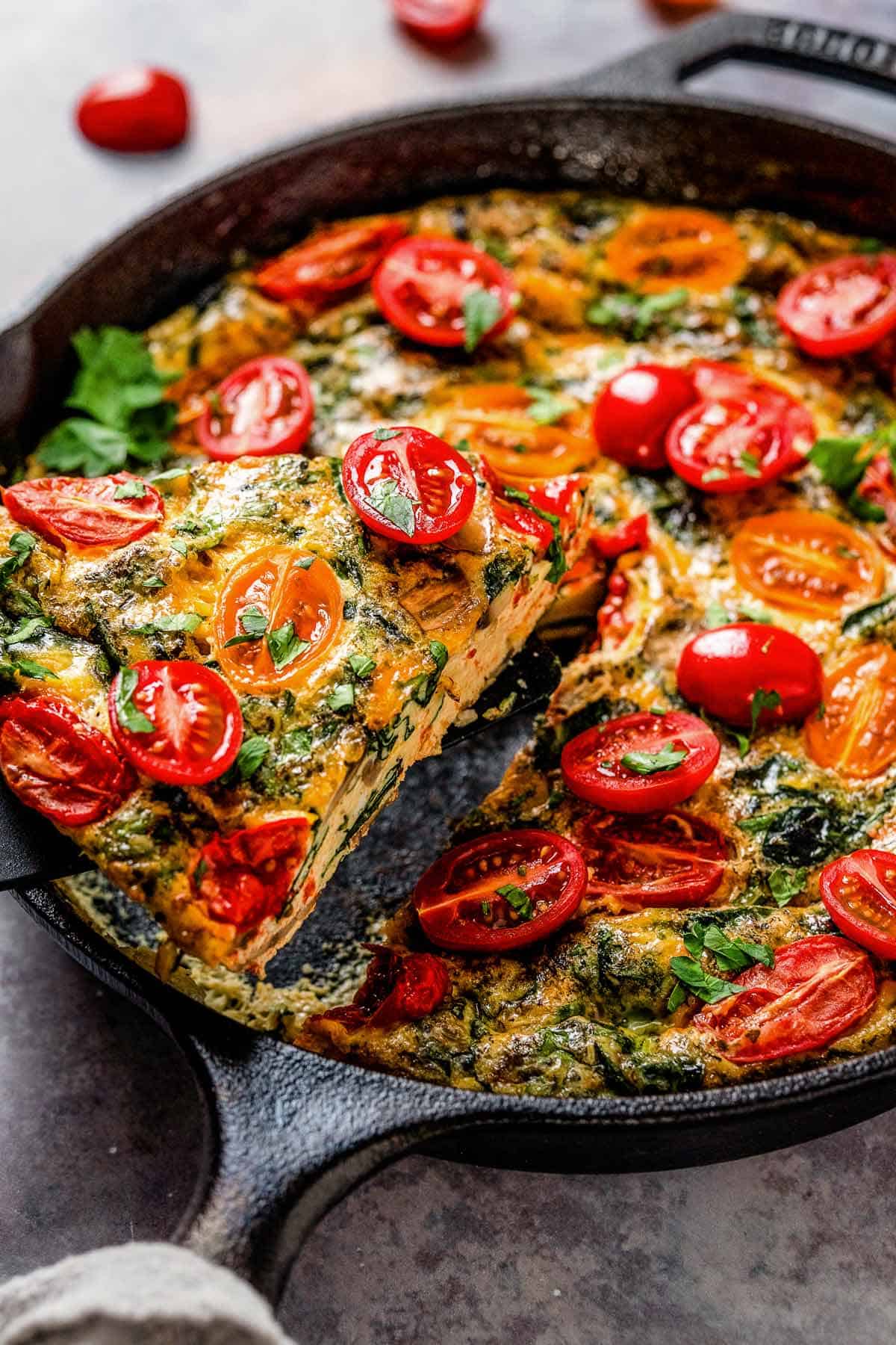 healthy vegetable frittata with spinach and tomatoes.