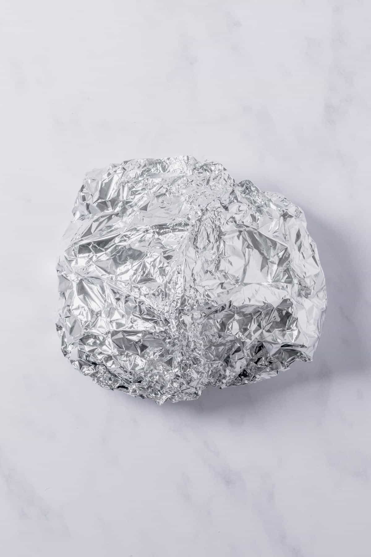 foil packet with vegetables and beef wrapped into a packet