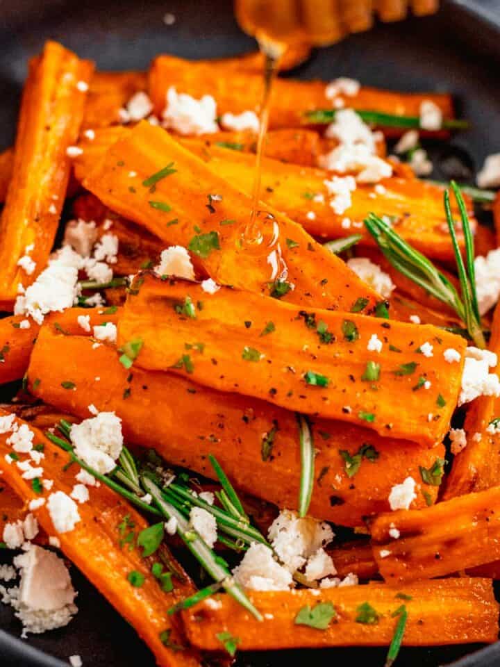 Honey Glazed Carrots In Air Fryer With Feta and Rosemary in a black bowl