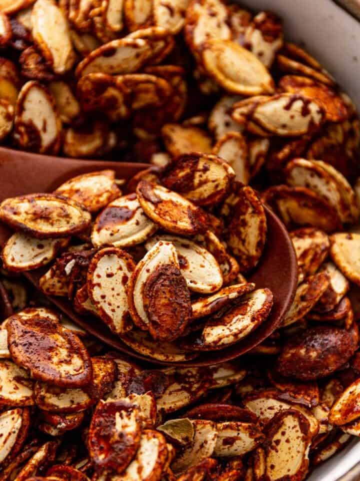 a bowl of crispy honey roasted pumpkin seeds.