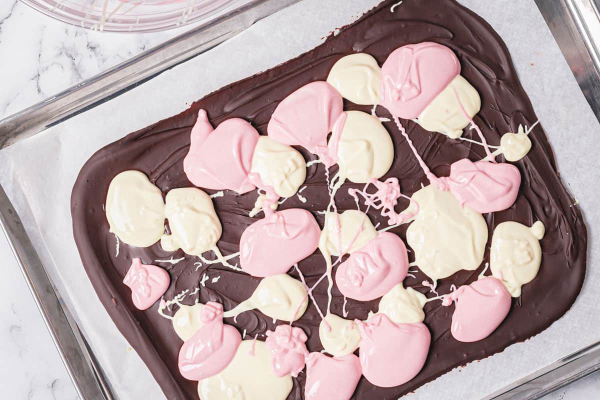 white and pink chocolate drizzled on top of milk chocolate