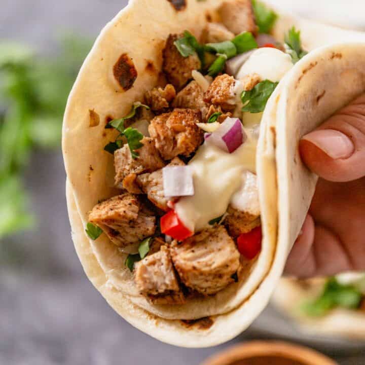 mexican chicken street tacos in hand