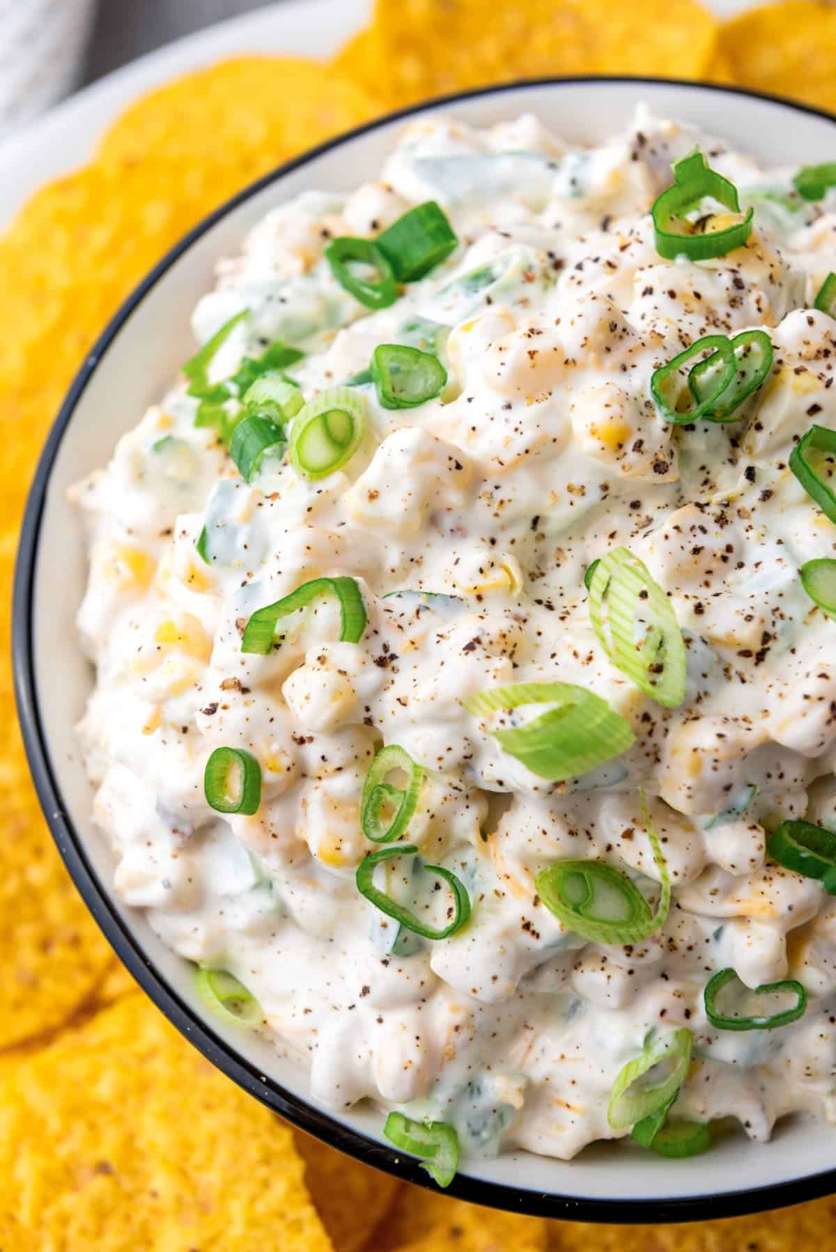 a bowl of mexican corn dip with sour cream