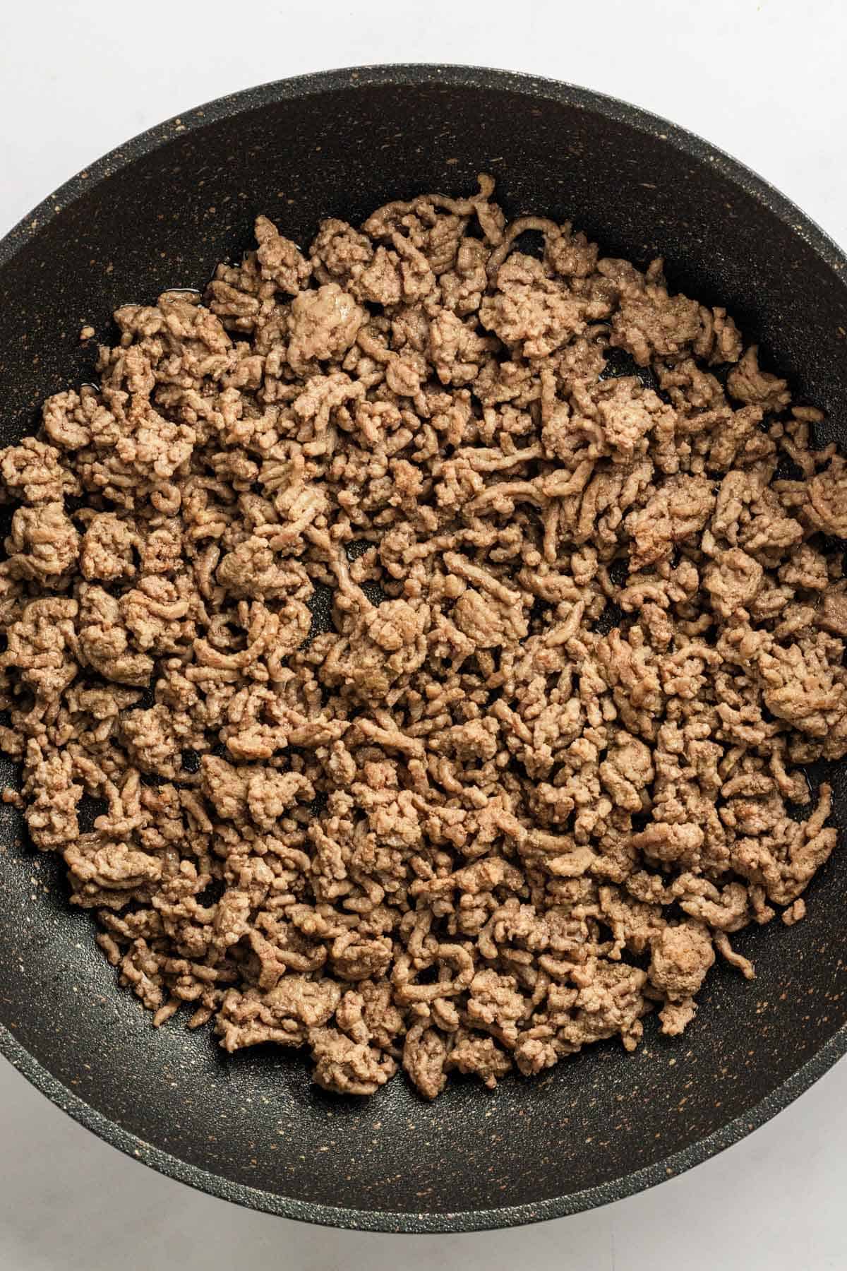 Browned ground beef in skillet.