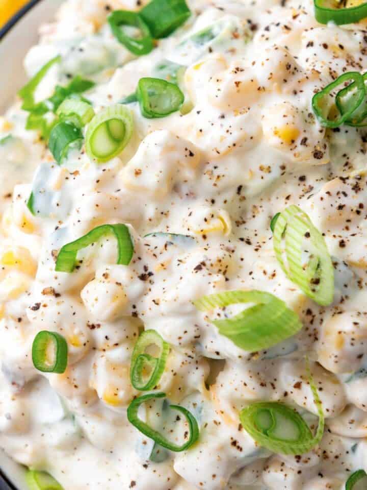 a bowl of sour cream corn dip.