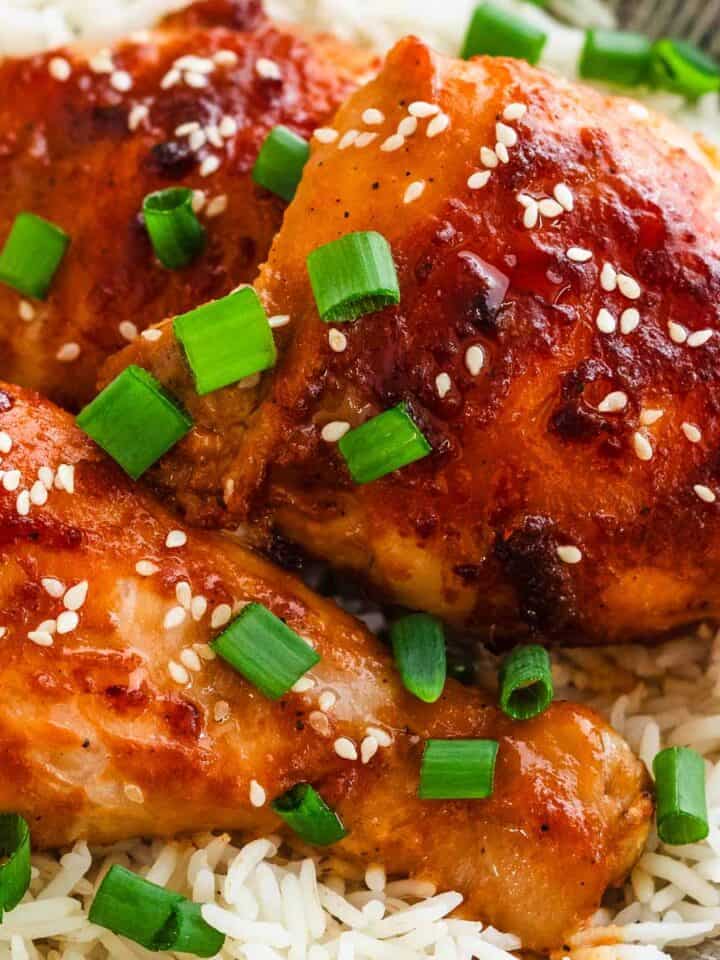 Honey miso chicken thighs served over rice with green onions.