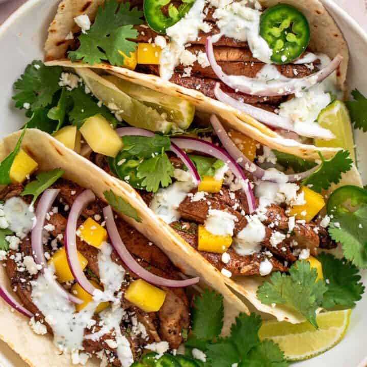 These smoky garlic mushroom tacos are quick, healthy, and full of flavor. Juicy portobellos, zesty lime, and a creamy cilantro sauce make this the perfect weeknight dinner!.
