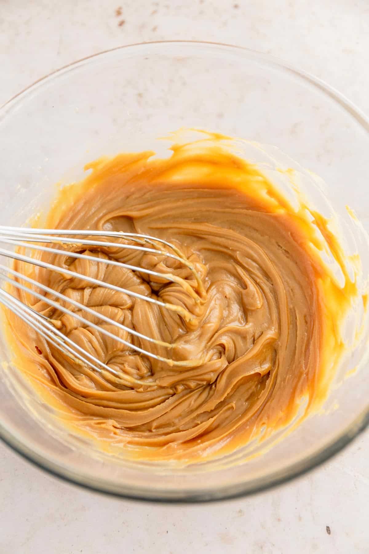 softened creamy peanut butter with maple syrup in a bowl