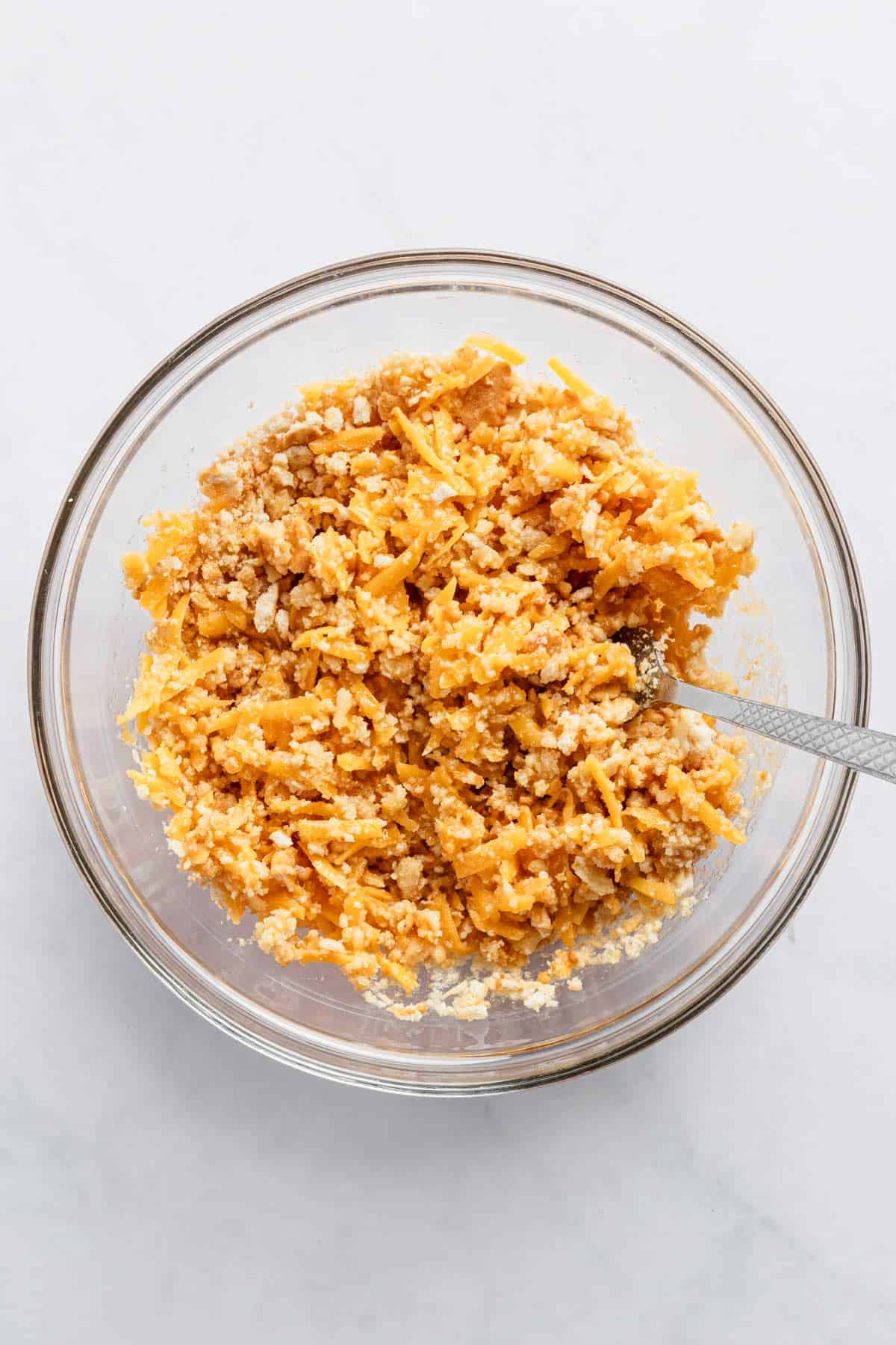 combining ingredients for cabbage casserole topping in a bowl.