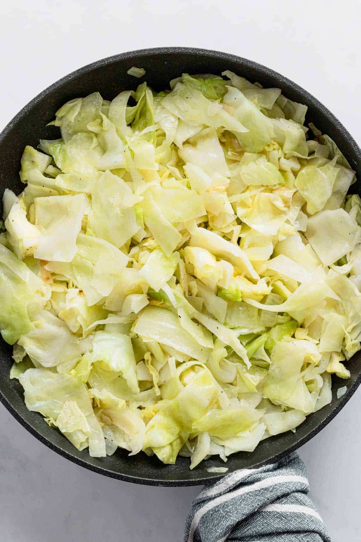 sauteing cabbage in skillet.