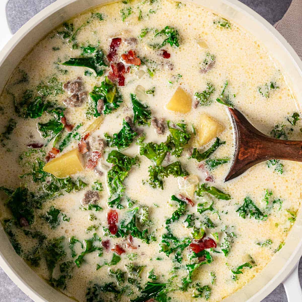 creamy kale sausage and potato soup in a bowl.
