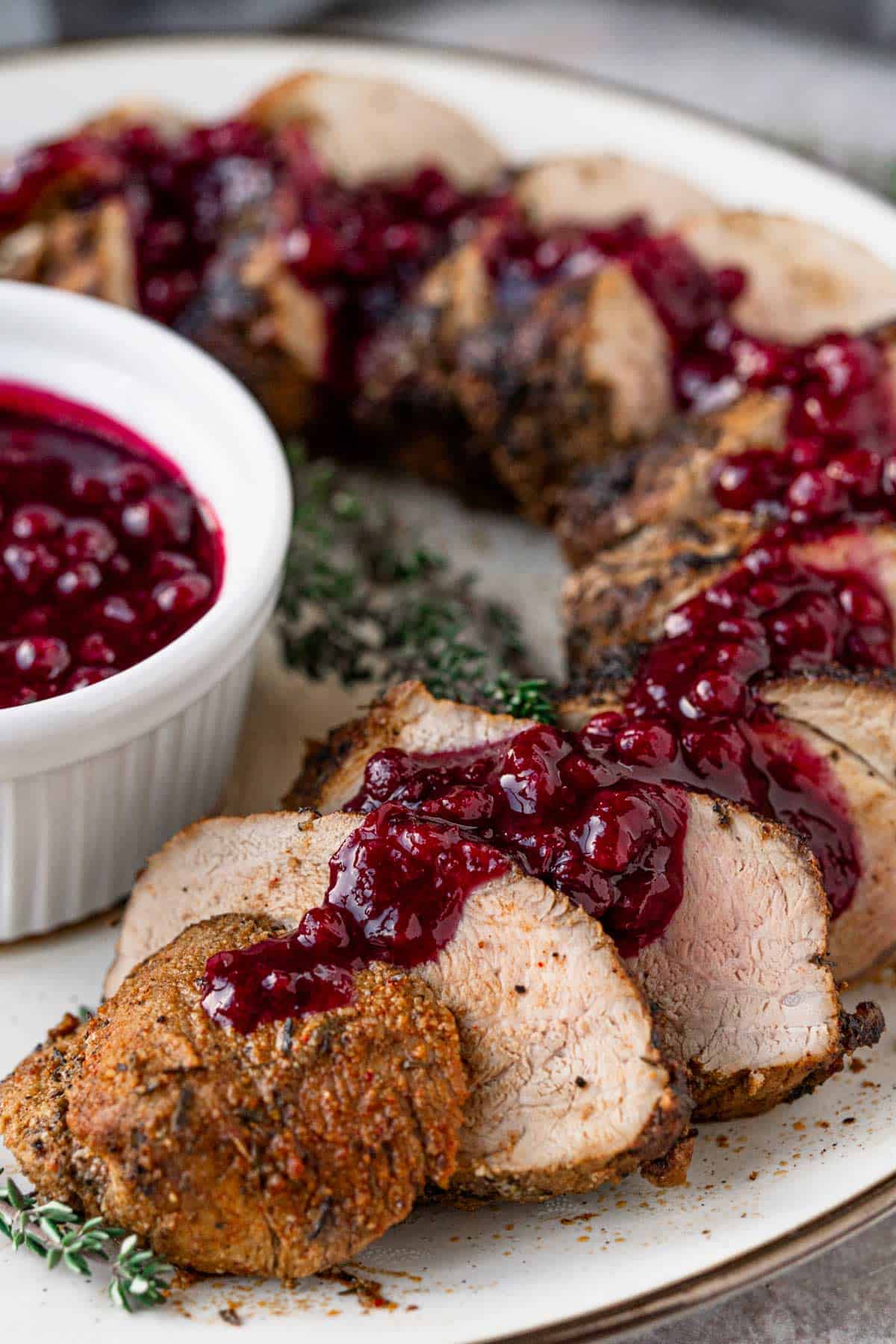 pork tenderloin slices served with berry sauce.