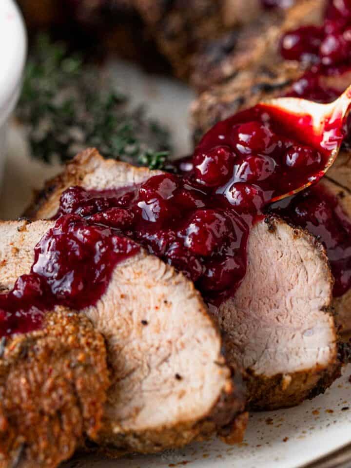 pork tenderloin slices served with berry sauce.