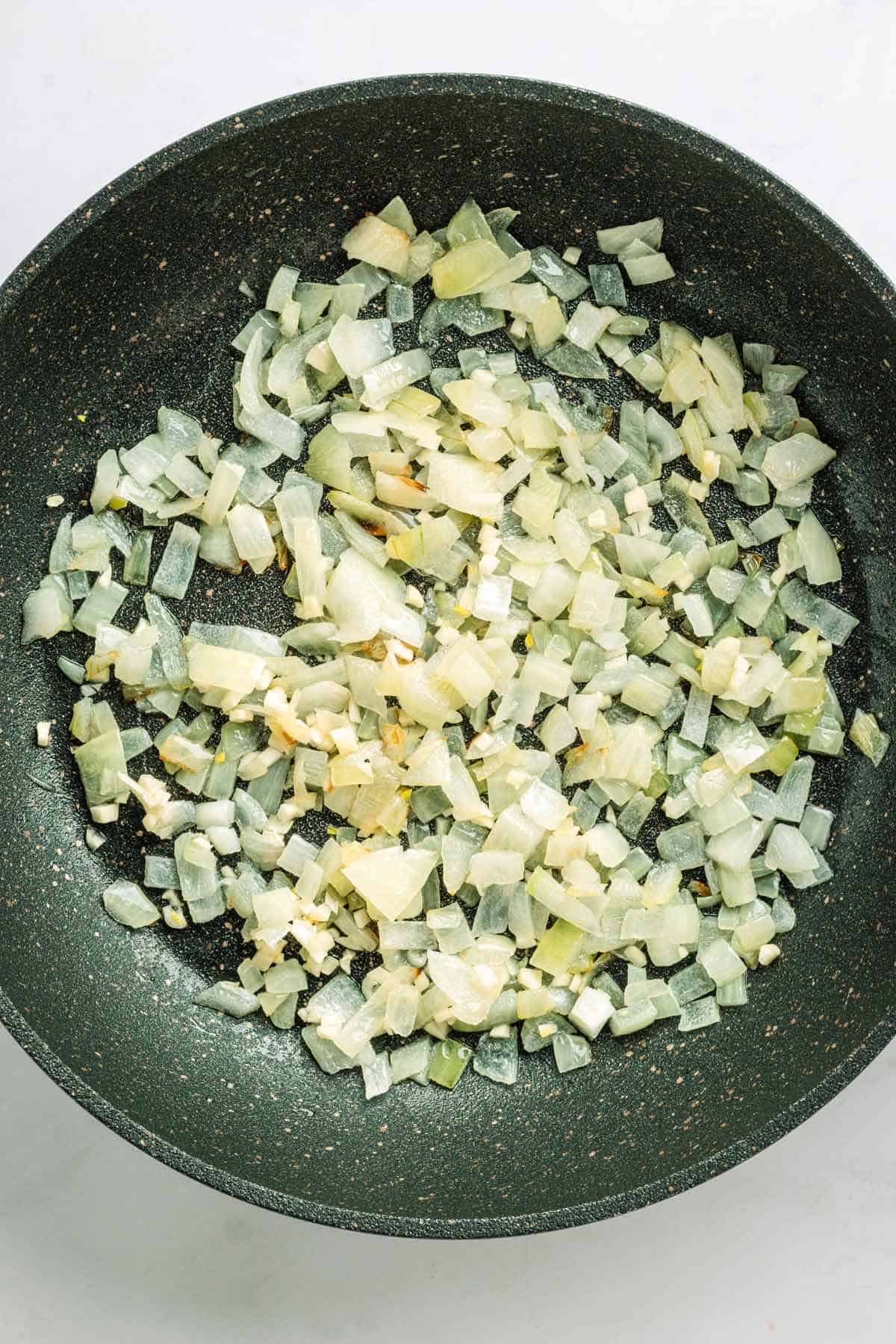 Sauteeing onions spinach potato casserole.