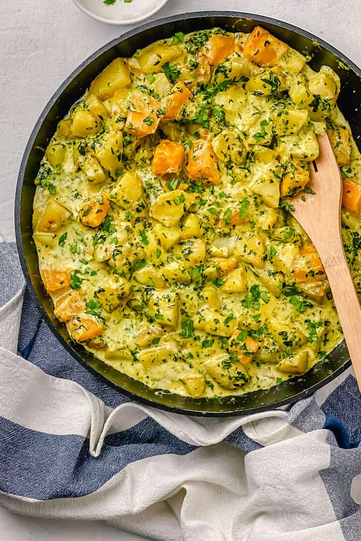 This Potato, pumpkin and spinach coconut curry is one of my favorite ways to eat potatoes. It’s creamy, fresh with the perfect blend of spices and the pumpkin in coconut sauce tastes absolutely incredible. Give it a try and enjoy it with flatbread or even rice on the side. #Potatospinachcurry #Potatospinachcoconutmilkcurry #Potatocurry #Potatoandspinachcurryvegan #potatospinachrecipe The Yummy Bowl