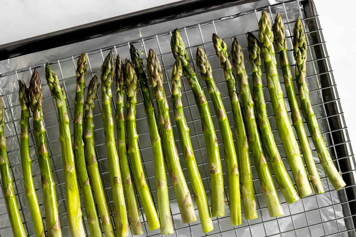 asparagus spears arranged on wire rack.