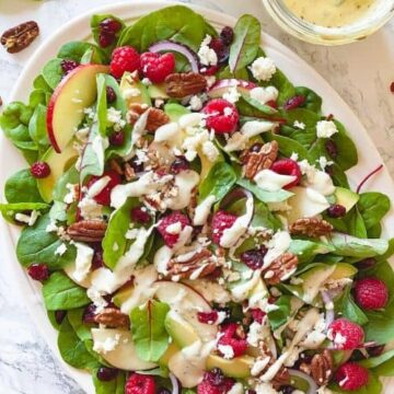 Raspberry, Spinach, and Beet Green Salad - healthy, summer salad recipe loaded with raspberries, pecans, fresh spinach, feta, and beet leaves. This recipe uses just a few ingredients and is simply delicious on its own. But what makes this salad unforgettably delicious is the Creamy Greek Yogurt Herb Dressing. - The Yummy Bowl