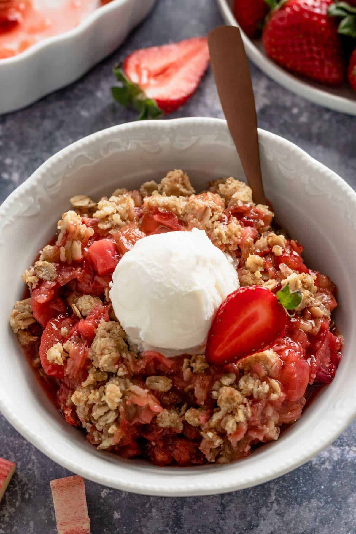 Strawberry Rhubarb Crisp in a bowl and ice cream