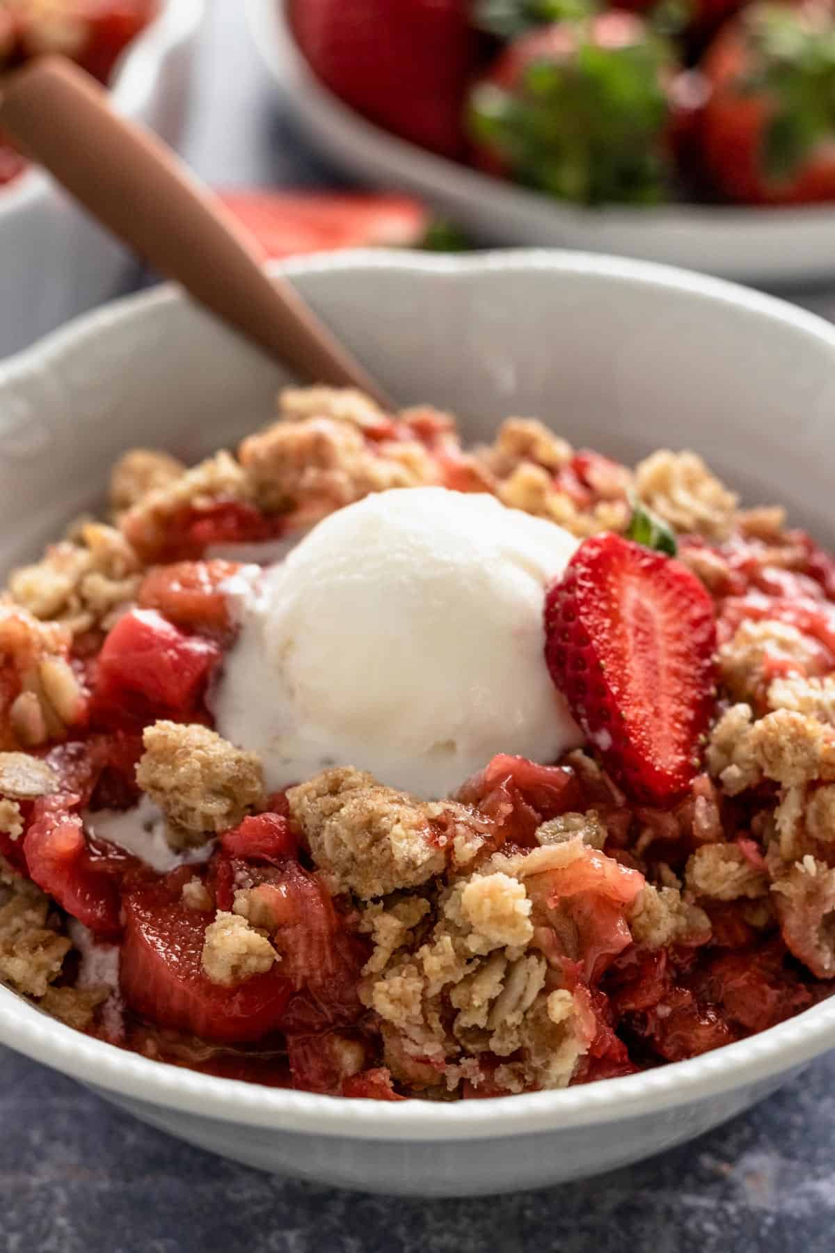 Strawberry Rhubarb Crisp in a bowl with ice cream