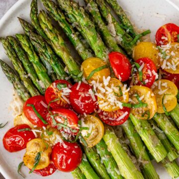 roasted asparagus with cheese and tomatoes.