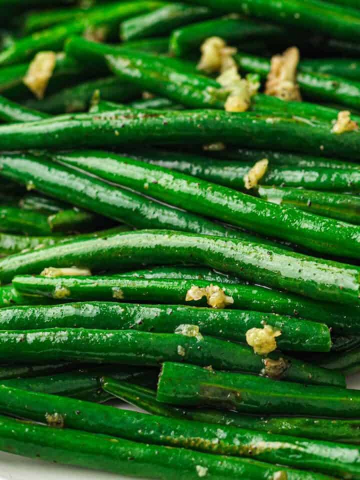 Green beans seasoned with salt and pepper in a skillet.