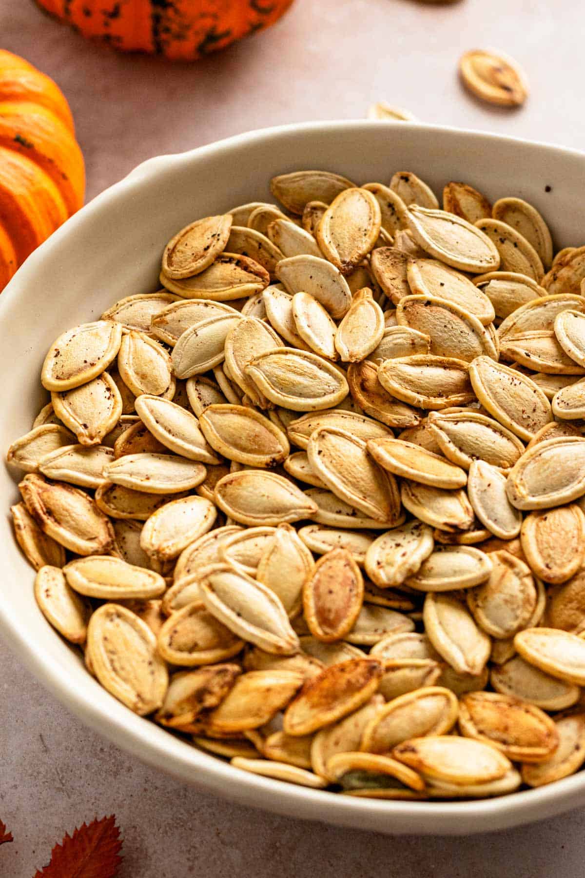 golden brown pumpkin seeds in a bowl.
