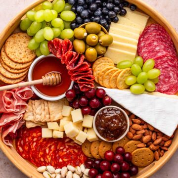charcuterie board with meat cuts, cheese and fruit.