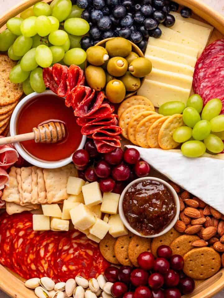 charcuterie board with meat cuts, cheese and fruit.