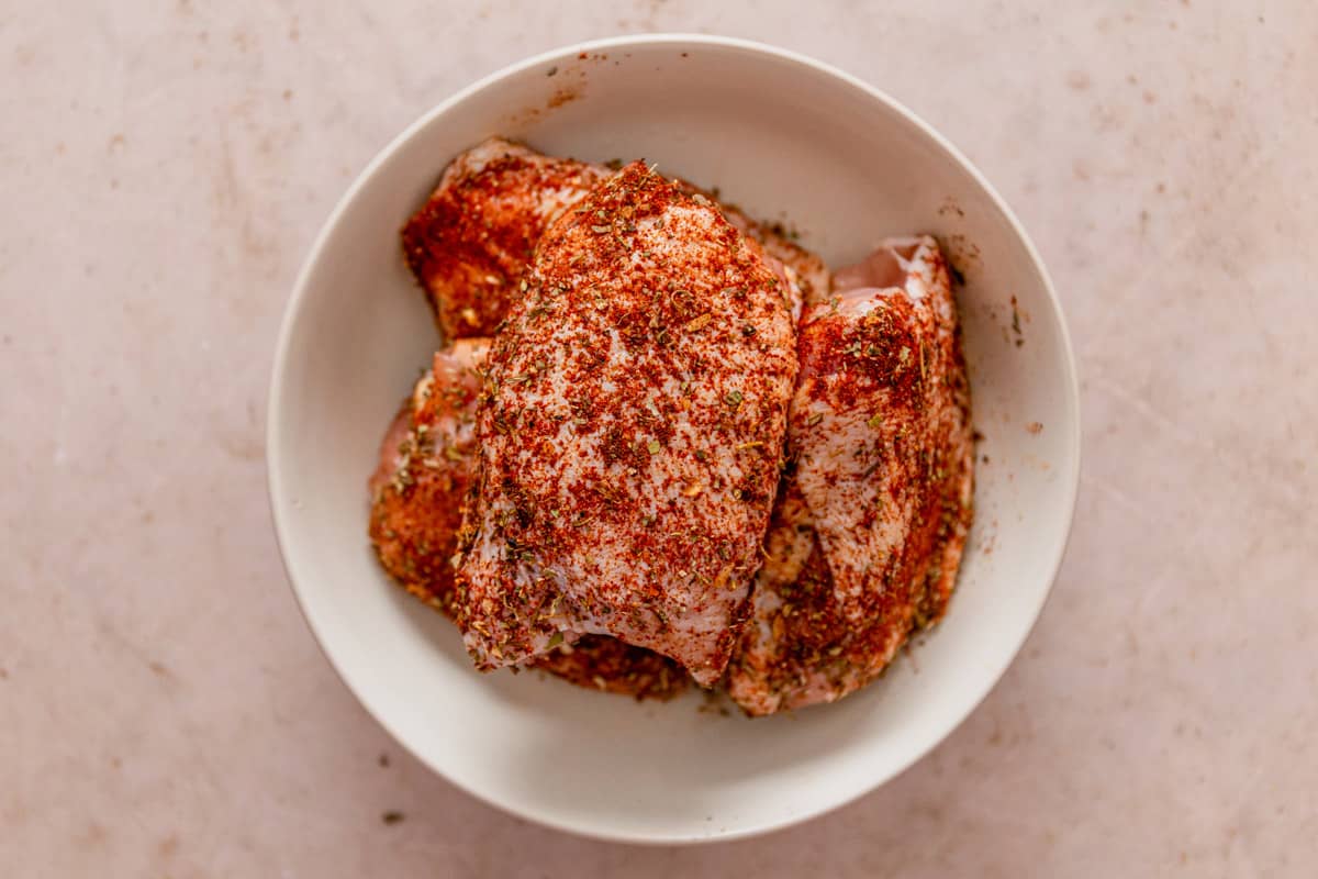 dry rubbed chicken thighs for chicken cacciatore in a bowl
