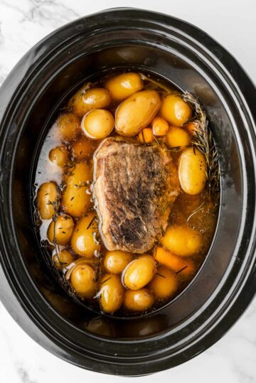 cooked rump roast with vegetables in slow cooker