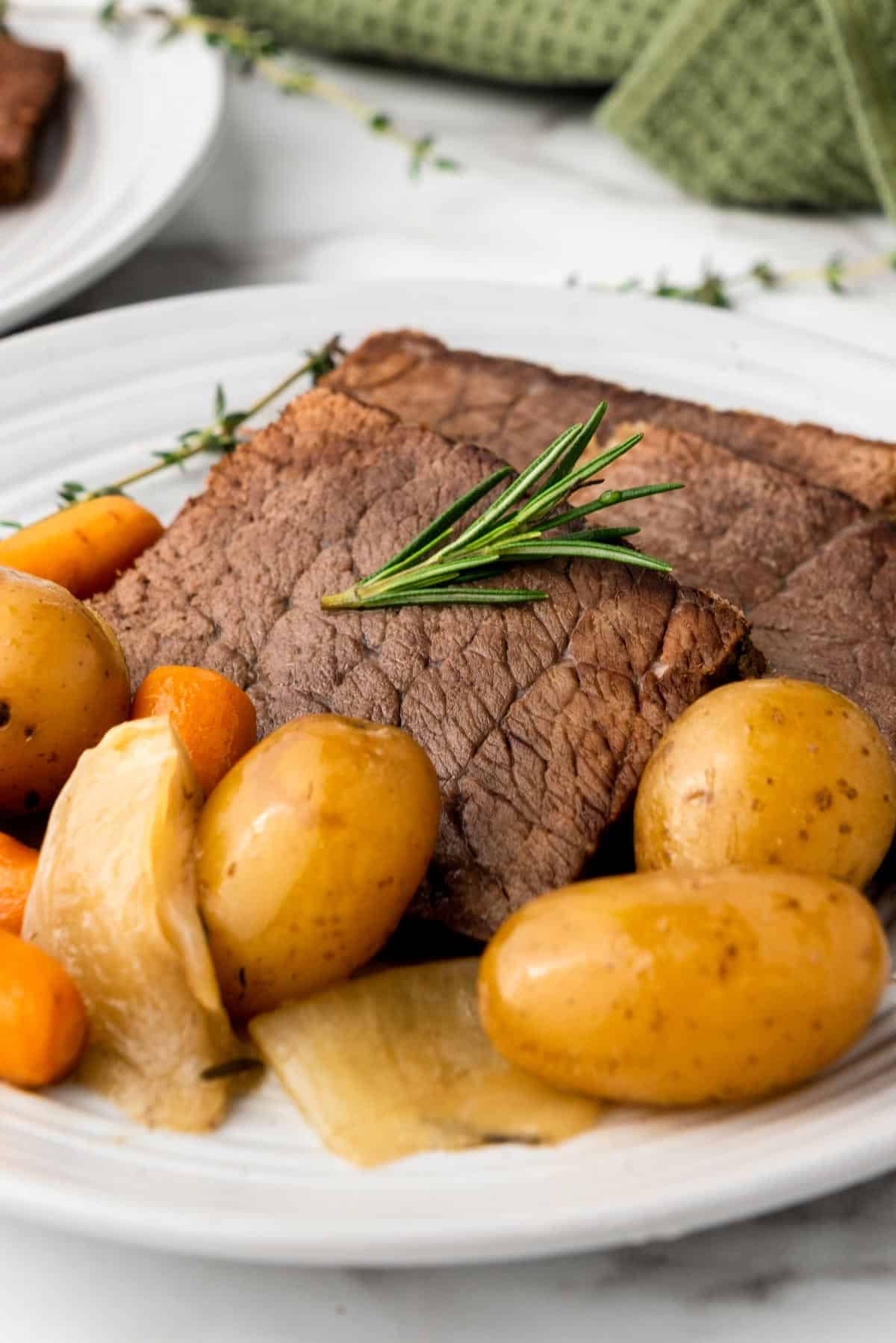slow cooker rump roast with vegetables on a plate