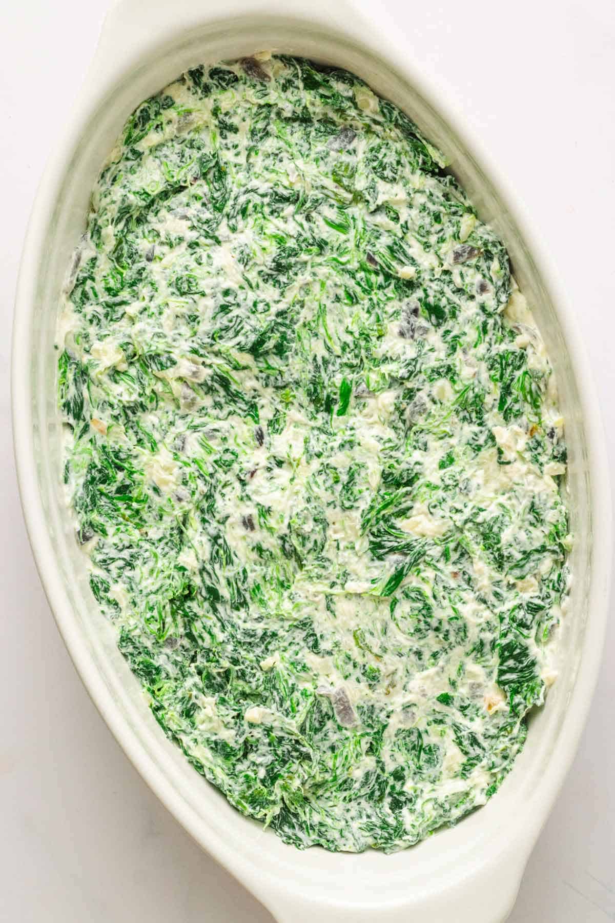 Creamy spinach mixture in baking dish.