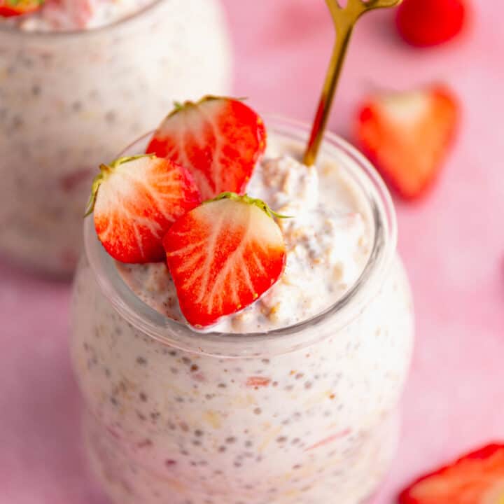 creamy oats and strawberries in a glass jar.