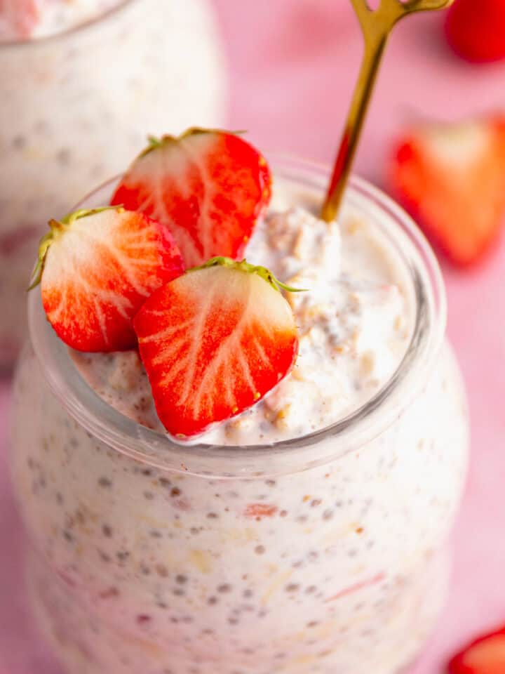creamy oats and strawberries in a glass jar.