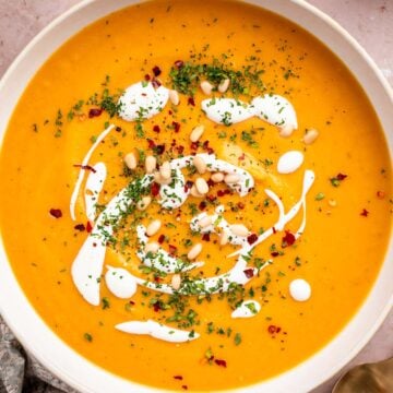 Vegan sweet potato soup with coconut milk and toppings.