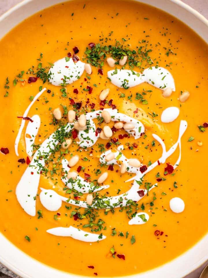 Vegan sweet potato soup with coconut milk and toppings.
