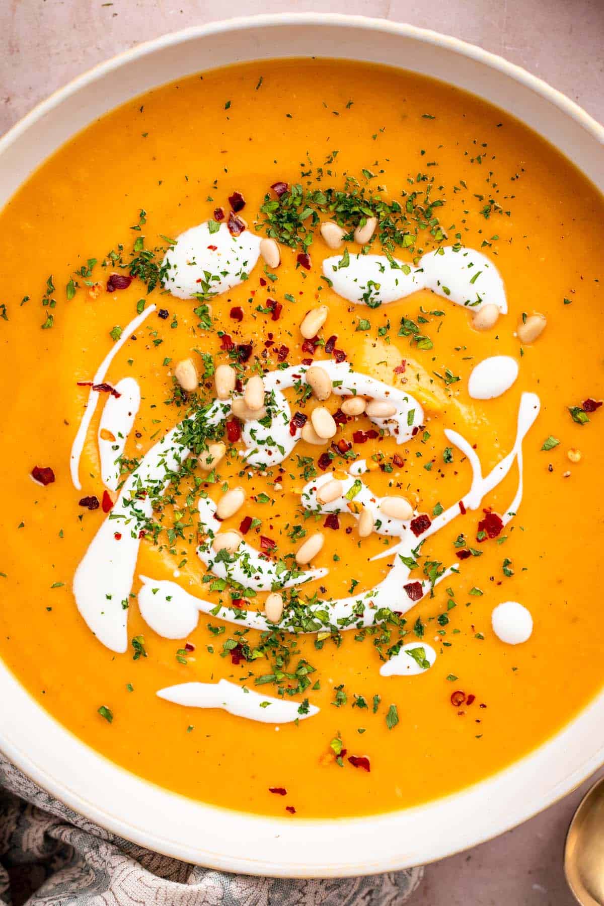 Vegan sweet potato soup with coconut milk and toppings.