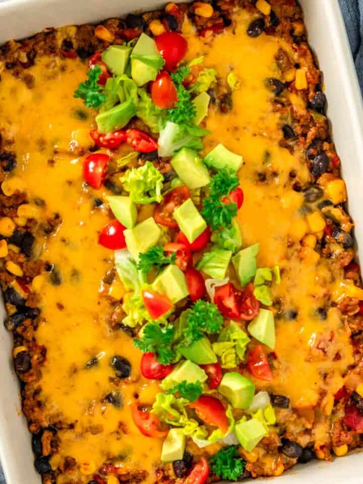 taco casserole with diced tomatoes avocado and cilantro